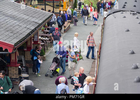 Busy train station platform at Haverthwaite preserved heritage railway in the Lake District as passengers disembark from the newly arrived train. Stock Photo