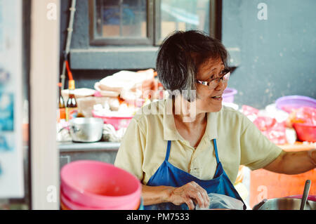 Kuala Lumpur, Malaysia - 10 September, 2017: Chinese street vendor sells food on Jalan Petaling  in Kuala Lumpur, Malaysia Stock Photo