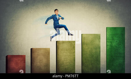 Confident businessman fast jumping up on the top of a graph. No limits growing success concept, business metaphor as keep on moving forward. Stock Photo