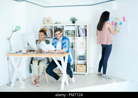 Three People Working in Small Design Studio Stock Photo