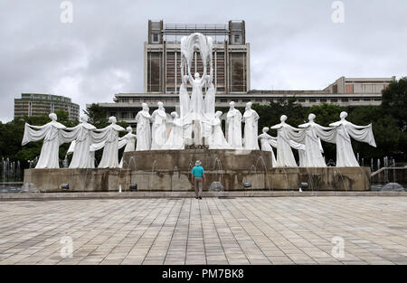 Tourist admiring the sculpture called Snow Falls at Mansudae Fountain Park in Pyongyang Stock Photo