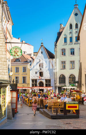 Tallinn restaurant, view of people sitting at restaurant tables on a summer afternoon along Vanaturu kael in the medieval Tallinn Old Town, Estonia. Stock Photo