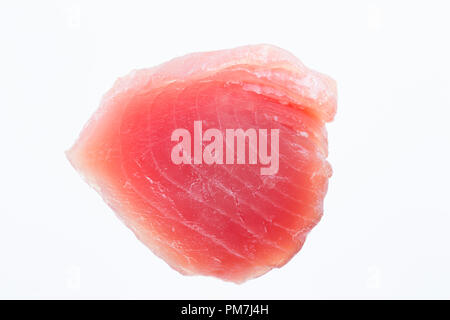 A raw  line-caught Yellowfin tuna, Thunnus albacares, steak bought from a supermarket in the UK and photographed on a white background. Dorset England Stock Photo
