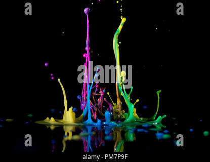 Abstract sculptures of colorful splashes of paint. Dancing liquid on a black background. Ink water splash. Color explosion. Stock Photo