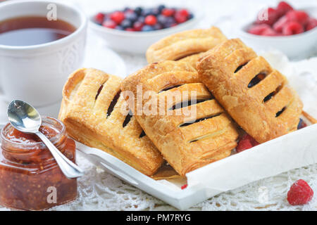Homemade puff pastry pies with raspberries and blueberries. Selective focus Stock Photo