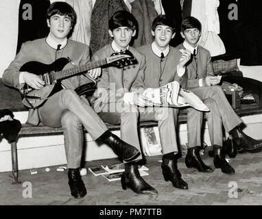 The Beatles, John Lennon, George Harrison, Paul McCartney and Ringo Starr, sitting on a bench in matching gray suits, 1963.  File Reference # 31386 790 Stock Photo