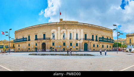 VALLETTA, MALTA - JUNE 17, 2018: Grandmaster's Palace, nowadays housing museums and President's office, located on Republic street and facing St Georg Stock Photo