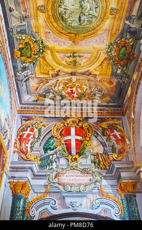 VALLETTA, MALTA - JUNE 17, 2018: The wall and ceiling in corridor of Grandmaster's Palace are covered with masterpiece murals with painted collumns, s Stock Photo