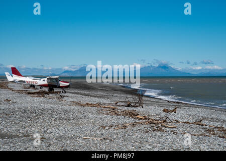 Two Cessna bush planes landed on a beach in Alaska's Katmai National Park. Mountains and active volcanoes in background Stock Photo