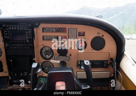 Copilot controls inside of an Alaska bush plane - Cessna. Instrument panel, windshield of plane with rain Stock Photo