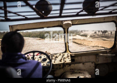 Riding in an old truck from the 2nd world war times among the sand dunes near Dakar Stock Photo