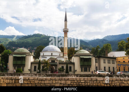 SARAJEVO / BOSNIA AND HERZEGOVINA - September 2, 2018: Outdoor view of Careva Dzamija mosque in Sarajevo on the miljacka riverbank. Stock Photo