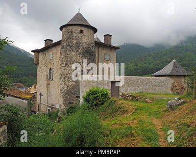 circular towers & tiled roofs of Seix Castle, overlook the town & valley of the Salat in the Ariège Pyrénées, France with clouds over Montagne du Cos Stock Photo
