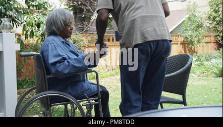 Disabled senior black woman in wheel chair with coffee Stock Photo