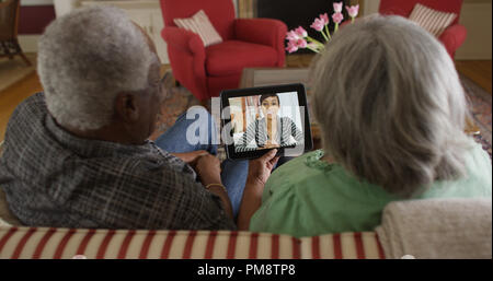Happy senior black couple video chatting with granddaughter Stock Photo