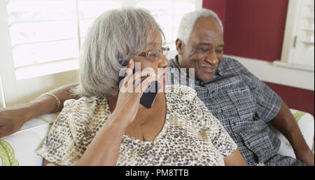 Elderly black woman chatting on the phone Stock Photo