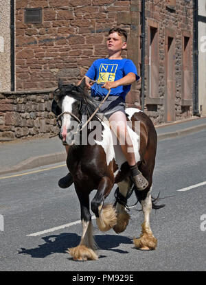 Gypsy Traveller boy riding horse. Appleby Horse Fair 2018. The Sands, Appleby-in-Westmorland, Cumbria, England, United Kingdom, Europe. Stock Photo