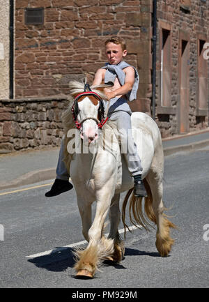 Gypsy Traveller boy riding horse. Appleby Horse Fair 2018. The Sands, Appleby-in-Westmorland, Cumbria, England, United Kingdom, Europe. Stock Photo