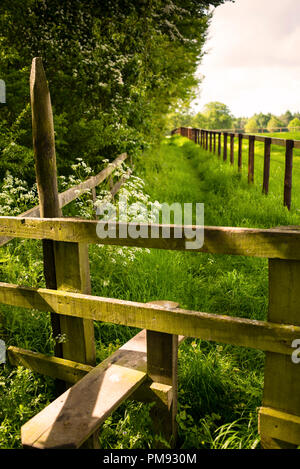 Step over wooden stile on a Public Footpath in the Cotswolds District of England. Stock Photo