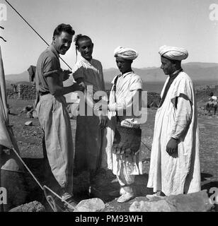 Morocco 1930s French Foreign Legion soldier inoculating vaccine to local tribesmen Stock Photo