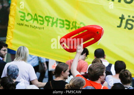 Frankfurt, Germany. 17th September 2018. A protester carries a life buoy. Around 6.300 protesters marched through Frankfurt, in support of the Seebrucke (Sea Lift) movement for the rescuing of refugees from the Mediterranean Sea. They also protested against the restrictive refugee policies of German Federal Interior Minister Horst Seehofer, who was due to speak at a congress in Frankfurt the following day, but whose appearance was cancelled. Credit: Michael Debets/Alamy Live News Stock Photo
