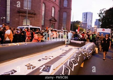 Frankfurt, Germany. 17th September 2018. A large inflatable boat, similar to the ones used by refugees in the Mediterranean, lies on the ground at the closing rally. Around 6.300 protesters marched through Frankfurt, in support of the Seebrucke (Sea Lift) movement for the rescuing of refugees from the Mediterranean Sea. They also protested against the restrictive refugee policies of German Federal Interior Minister Horst Seehofer, who was due to speak at a congress in Frankfurt the following day, but whose appearance was cancelled. Credit: Michael Debets/Alamy Live News Stock Photo