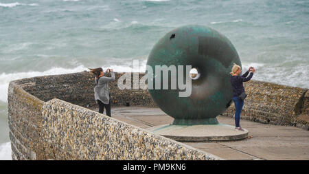 Brighton UK 18th September 2018 - Visitors try to photograph the waves on Brighton seafront as Storm Helene starts to hit Britain with winds of up to 70 mph expected in some parts of the UK over the next few days Credit: Simon Dack/Alamy Live News
