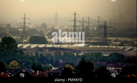 Glasgow, Scotland, UK, 18th September, 2018. UK Weather: Stormy weather ahead as the tower of the former Leverndale hospital is barely visible through the deluge that hit the city today with the pylons and shopping centre of Intu Braehead in the foreground. Gerard Ferry/Alamy news Credit: gerard ferry/Alamy Live News Stock Photo