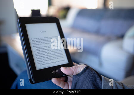 Amazon Kindle Paperwhite E-Book reading while waiting modern technology Stock Photo