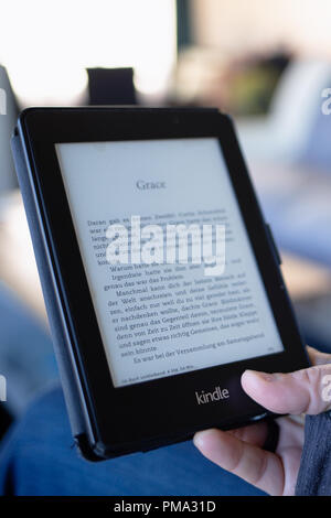 Amazon Kindle Paperwhite E-Book reading while waiting modern technology Stock Photo