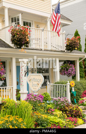 Front porch entrance, surrounded by gardens to a quaint Bed and Breakfast on the historic Mackinac Island. Stock Photo