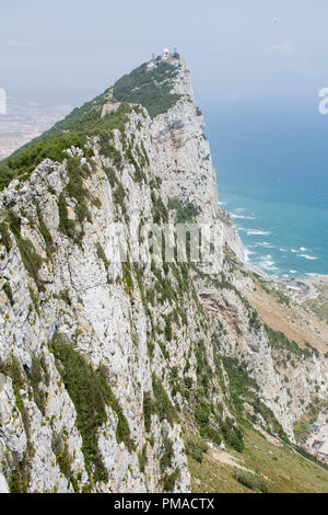 Looking down on the sheer face of the limestone cliffs on the east face of the Rock of Gibraltar. View from the 'Top of the Rock' viewing platform. Stock Photo