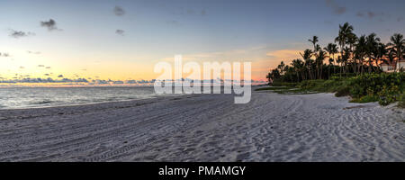 Dilapidated ruins of a pier on Port Royal Beach at sunset in Naples, Florida Stock Photo