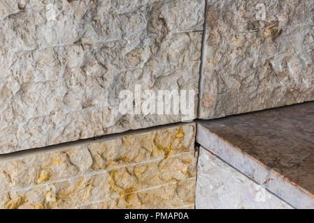 Symmetrical horizontal vertical angled lines of stone tiles of modern architecture facade of public building Stock Photo