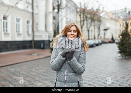 Stylish beautiful woman in winter fashion clothes in the city. Stock Photo