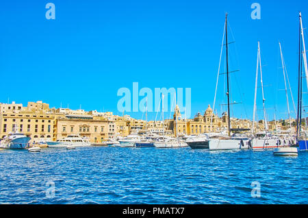 The luxury sailing yachts are moored along the Xatt Il-Forn promenade at Vittoriosa Marina, located between fortified cities of Birgu (Vittoriosa) and Stock Photo