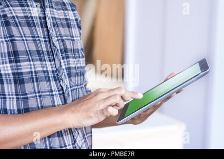 worker at furniture factory working on his pc tablet Stock Photo