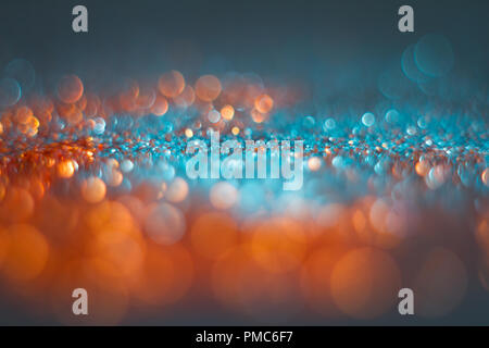 Abstraction orange bokeh on a blue background. Defocused. Free space for text. Stock Photo