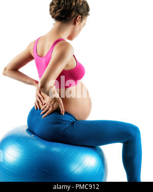 Lower back pain. Photo of pregnant woman holding her back in pain isolated on white background. Concept of healthy life Stock Photo