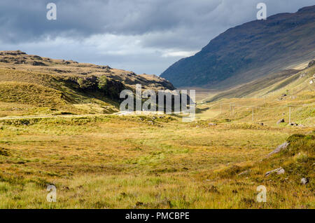 The A896 road meanders through the moorland valley of Glen Shieldaig, under Ben Shieldaig mountain, near Torridon in the west Highlands of Scotland. Stock Photo