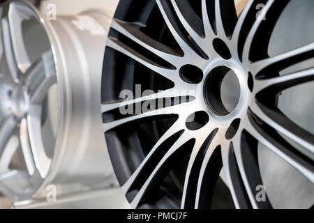 alloy wheels in wheel shop.Wheel rims on showcase. Car alloy wheels at a wheel shop or automobile exhibition.Stand with alloy wheels in modern tire store.SElrctive focus Stock Photo