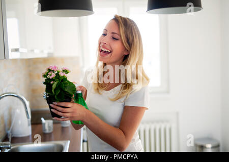 lovely housewife with flower in pot Stock Photo