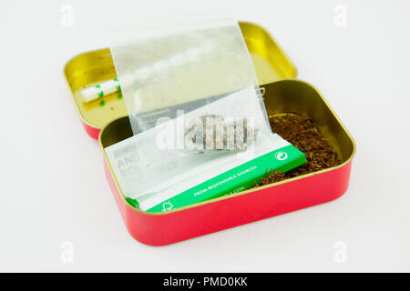 Health, Drugs, Cannabis, Tin of rolling tobacco with small bag of marijuana. Stock Photo