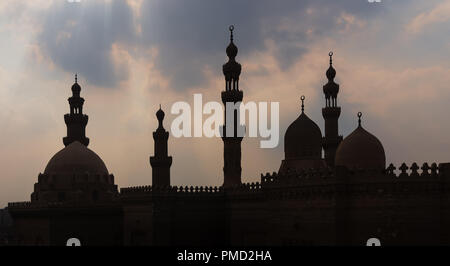 Silhouette shot of minarets and domes of  Sultan Hasan mosque and Al Rifai Mosque, Old Cairo, Egypt Stock Photo