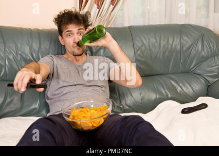 Man relax after work watching tv and drinking beer Stock Photo