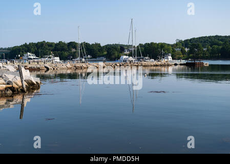 View of the harbor at Belfast Maine with the breakwater built of granite in the early morning light. Stock Photo