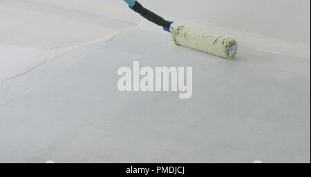 closeup applying primer on the floor Stock Photo