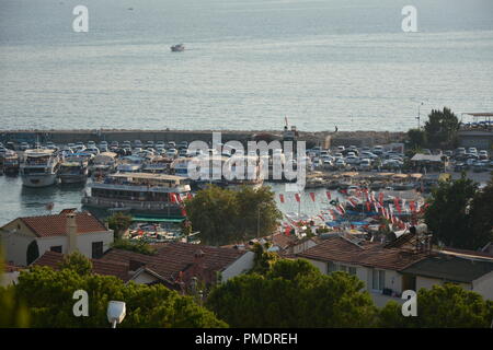 ANTALYA, TURKEY - AUGUST 31, 2018: The view of Kaş Marina and Cukurbag Peninsula through the buildings from a hill Stock Photo