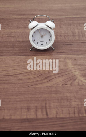 white twin bell alarm clock on table Stock Photo