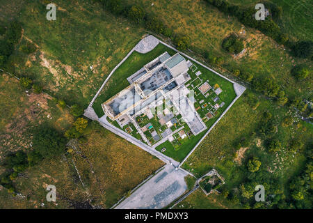 Corcomroe Abbey ruins and its cemetery located in the Burren region of County Clare, Ireland. Aerial view from a drone looking down. Stock Photo